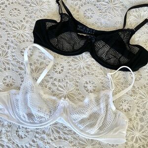 Two black and white semi sheer lace bras